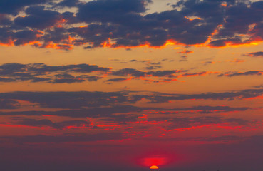 beautiful red sunset and bright sun on the horizon