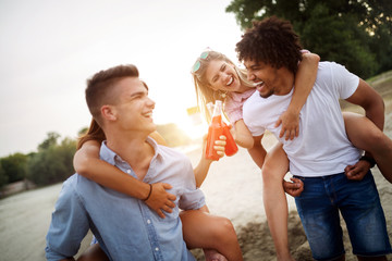 Group of friends having fun on the beach. Summer holidays, vacation and people concept.