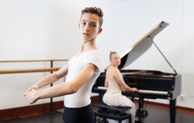 Young dancer studying ballet to the music