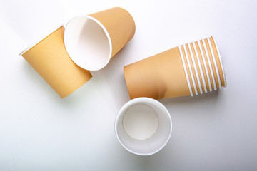 Paper cup for coffee. White table. Top view.