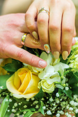 Fototapeta premium Just married young couple with bouquet of flowers