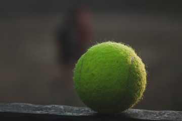 tennis ball lying on a metal stand