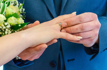 Just married young couple with bouquet of flowers