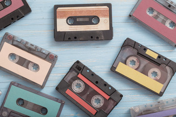 Old plastic cassette on wooden background. Retro music concept