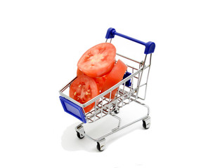 Fresh tomatoes in small shopping cart on white background image
