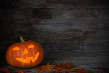 Naklejka na ściany i meble Halloween pumpkin on old wooden background