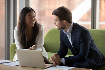 Business colleagues brainstorm discussing project at office