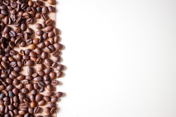 Coffee beans on braun background.