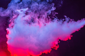 Fototapeta na wymiar Colourful cloud of vapor. dark black background
