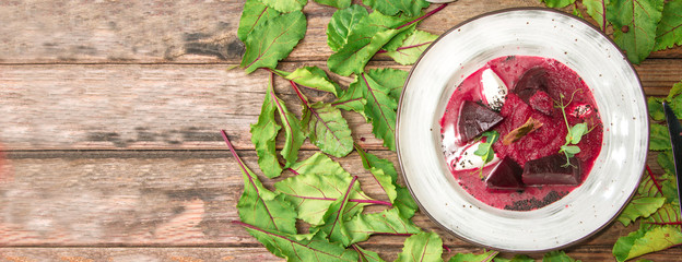 Thick beet soup with mozzarella and parsley in gelatin, sprinkled with sesame seeds, garnished with young pea sprouts