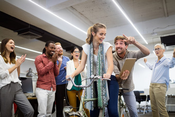 Carefree diverse office workers having fun during work break