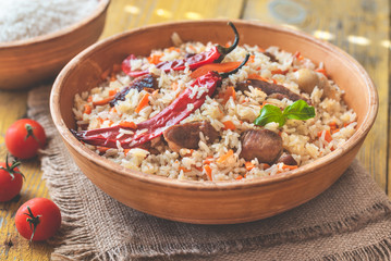 Bowl of pilaf on the wooden table