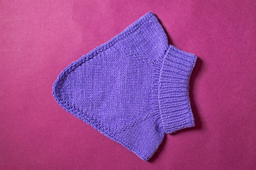 Flat lay woolen autumn or winter clothing. Top view sweater for children.