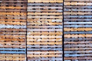 Empty wooden crates or pallets in factory or plant warehouse background