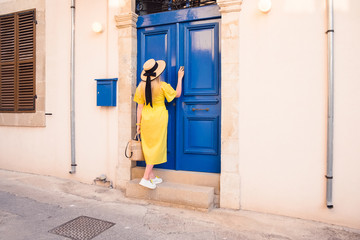 Woman walking in yellow dress at Paphos old city