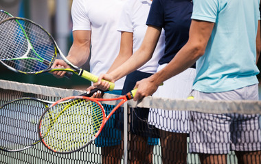 Fit happy poeple playing tennis together. Sport concept