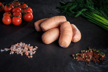 group of thick short sausages with onion, dill, and tomatoes