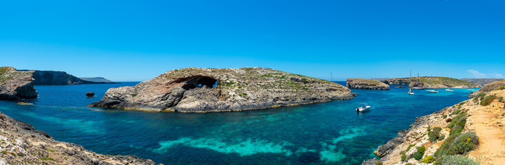 Fototapeta na wymiar Stone cliffs on the blue lagoon of the island of Comino and Gozo Malta. Mediterranean Sea
