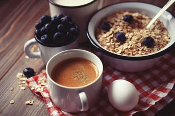 A healthy breakfast - oatmeal, boiled egg, milk, fresh berries and coffee. A great start to a new day.