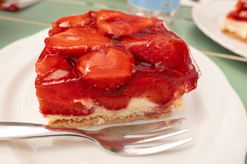 fresh delicious strawberry slices on a white plate with fork
