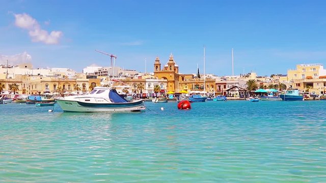 Aerial view on the mediterranean traditional colorful boats Luzzu. Fisherman village in the south east of Malta. Sunny day in Marsaxlokk, Malta.