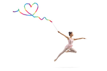 Female gymnast making a heart shape with a ribbon