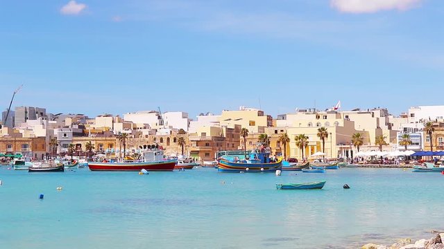 Aerial view on the mediterranean traditional colorful boats Luzzu. Fisherman village in the south east of Malta. Sunny day in Marsaxlokk, Malta.