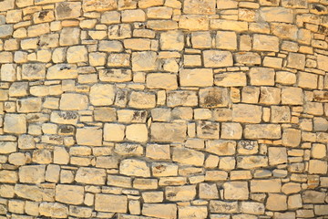 Fototapeta premium Big yellow wall from stone bricks