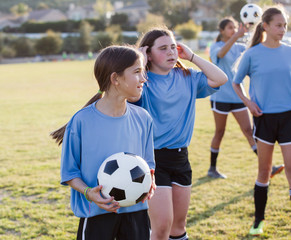 Girls practicing soccer on field © Cavan for Adobe