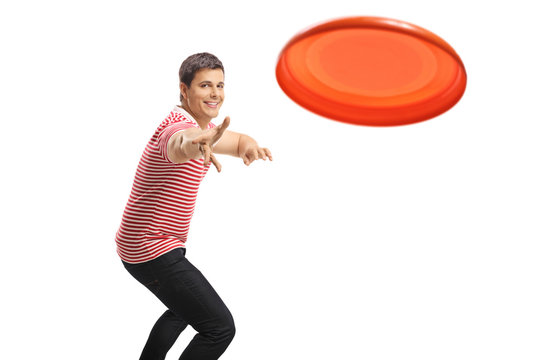 Young handsome guy throwing a frisbee