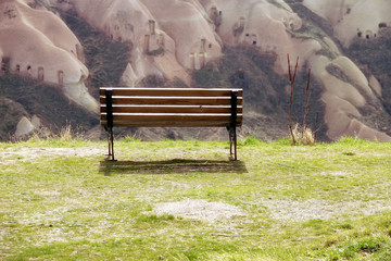 close up empty bench on green grass landscape hill