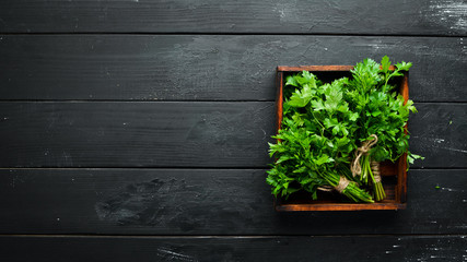 Fresh parsley on a wooden background. Top view. Free space for your text.