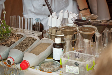 Soil experiments at the scientific fair. Test tubes with soil samples. An overview of the blurring of rocks by groundwaters.