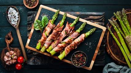Asparagus baked with bacon and spices. Healthy food. Top view. Free space for your text.
