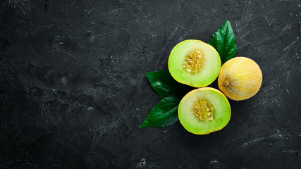 Fresh melon on black background. Top view. Free space for your text. - obrazy, fototapety, plakaty