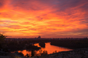 Dramatic, colorful city sunset. Orange, pink, and purple sky colors. Beautiful city skyline. The...