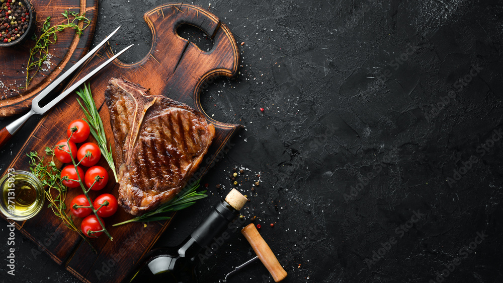 Wall mural grilled steak on a stone table. top view. free space for text.