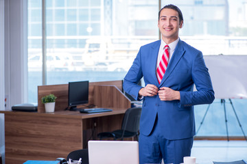 Young handsome businessman sitting in the office 