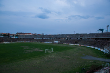 Abadoned Stadion Za  Luzankami is a currently inactive stadium in Brno, Czech Republic. Captured in spring sunset, sky and clouds was colored to blue dark colors. Photo from tribunes and inside middle