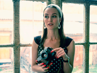 Girl in polka dot dress with retro camera
