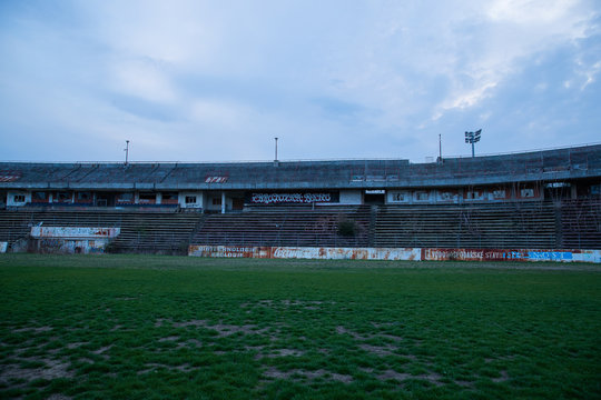 Abadoned Stadion Za  Luzankami is a currently inactive stadium in Brno, Czech Republic. Captured in spring sunset, sky and clouds was colored to blue dark colors. Photo from tribunes and inside middle