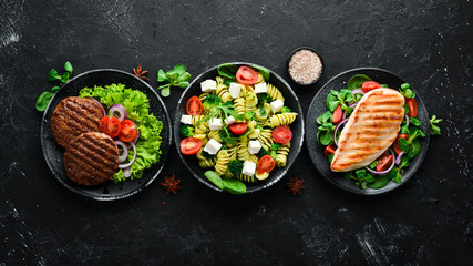 Assortment of food. Folk cuisine on a black wooden background Top view. Free space for your text. Flat lay