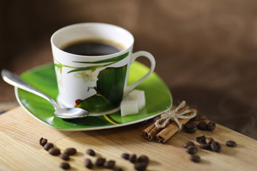 cup of coffee and white flowers on wooden table