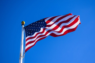 Close-up USA Flag Waving on a High Quality Clear Blue Sky