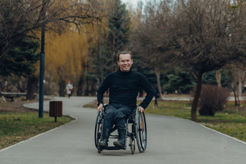 Portrait of a happy man on a wheelchair in a park