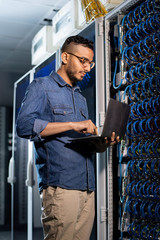 Concentrated network engineer examining database server