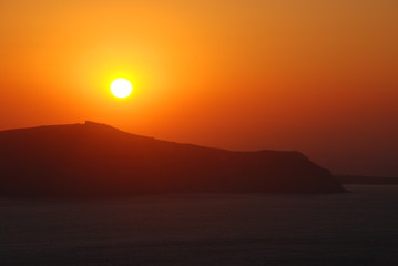 The volcano of Fira at Sunset as seen from the Santorini Island