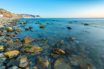 Stony sea beach of the 40th anniversary of the victory of the high coast of Anapa at sunset, Black Sea, Anapa, Russia