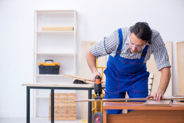 Young male carpenter working indoors 