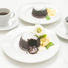 Warm Chocolate Lava Cake with Bite Taken Out of liquid Center. Cocoa dessert with vanilla ice-cream. 